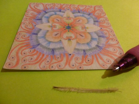 For some perspective, here is the feather next to a pen. (I added my mandala for color.)