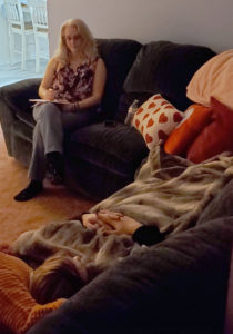 Karen Kubicko intently listens and takes notes on what the person is remembering during a past life regression session.