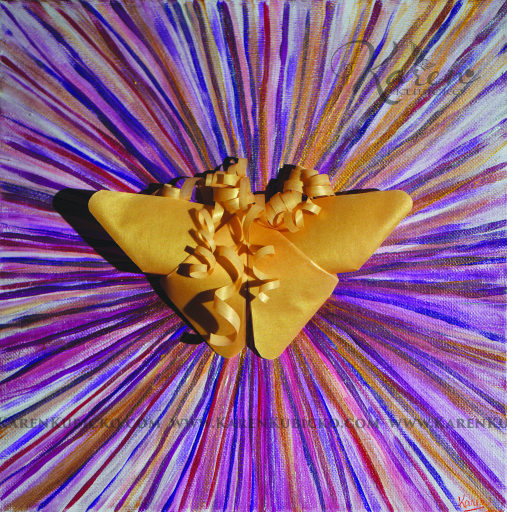 A golden origami butterfly sits on top of a radiant purple, golden, magenta, colorful streams of light. Karen Kubicko utilizes the intuitive psychic skill of sight (Clairvoyance) and hearing (Clairaudience) to bring visions of spiritual events to the canvas. All art is infused with healing Reiki energy. Karen uses oils, acrylic, and paper to bring these visions to life.